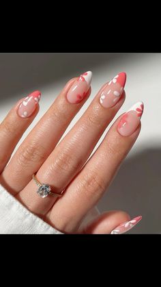 a woman's hand with pink and white nail polish