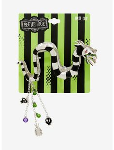 a green and black striped card with a snake charm on it's side, attached to a silver chain