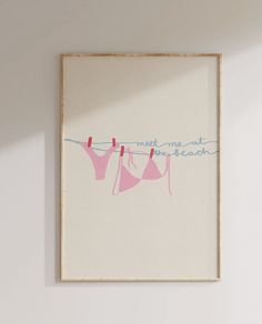 an art print hanging on the wall with clothes hung to dry in front of it