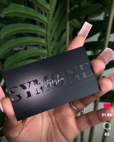 someone holding up a black business card with the words gym and fitness printed on it