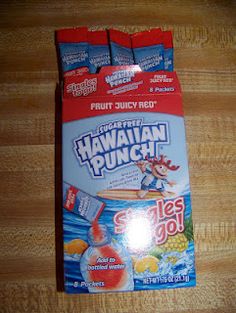 three packets of hawaiian punch sitting on top of a wooden table