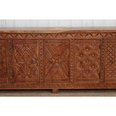 an old wooden sideboard with intricate carvings on it