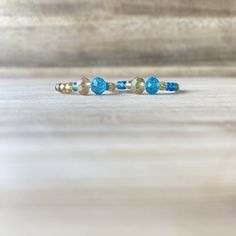 These beautiful rings, will make you look expensive, whilst also being on a budget😉. Handmade out of 0.8mm transparent elastic string, gold and blue seed beads and crystal beads. Make sure to select your ring size and your option, in the sections above.  💖Check out our other ring collections: https://www.etsy.com/shop/Zooheela?ref=seller-platform-mcnav&section_id=48579398 ABOUT DELIVERY: Shipment time might vary, depending on where you live; however, we place a huge importance on the delivery Blue Birthstone Beaded Bracelets, Blue Beaded Bracelets With Birthstone, Adjustable Birthstone Jewelry Band, Dainty Blue Rondelle Jewelry, Blue Spiritual Stackable Jewelry, Blue Stackable Jewelry With Round Beads, Blue Faceted Beads Bangle Jewelry, Blue Faceted Bead Bangle, Blue Bangle With Faceted Beads