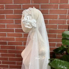 a white veil on top of a mannequin