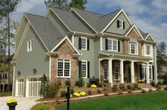 a large gray house with lots of windows