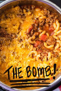 the bowl is full of macaroni and cheese, meat, and sauce with the word the bomb written on it