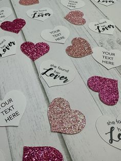 valentine's day gift tags with glitter hearts on white wood background, closeup