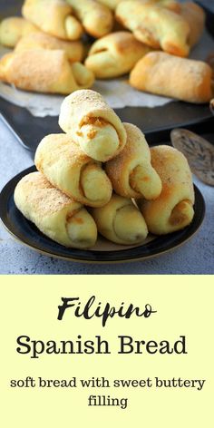 a pile of bread sitting on top of a plate next to a pan filled with rolls