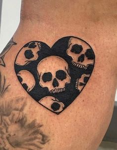 a woman's thigh with skulls in the shape of a heart