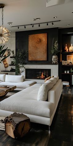 a living room filled with furniture and a fire place under a painting on the wall