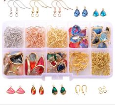 an assortment of jewelry and earrings in a plastic container with earring hooks, clippers, and clips