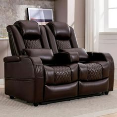 two brown reclining chairs sitting on top of a rug