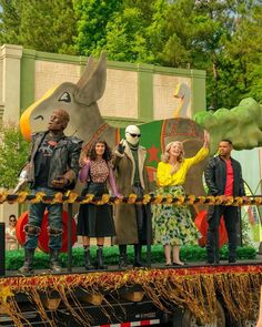 a group of people standing on top of a float