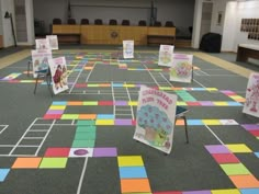 a large room filled with lots of different colored papers on top of a carpeted floor