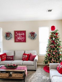 a living room decorated for christmas with red and white decor