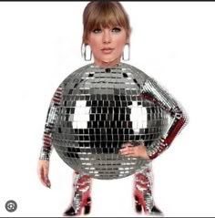 a woman is standing in front of a disco ball