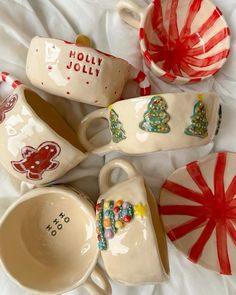 christmas themed dishes and candy canes laid out on a white sheet with the words holly jolly written on them