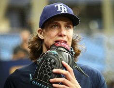 a close up of a baseball player holding a glove