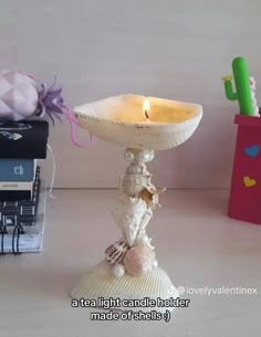 Seashells have been glued together to form a candlestick that holds a tealight candle. The base and the top that holds the candle are clamshells, and the middle is made of various other shells and some pearls. Sea Glass Interior Design, Clay Sculpture Air Dry, Seashell Projects Diy Beach Crafts, Mermaidcore Bedroom, Seashell Crafts Diy Home Decor, Mermaidcore Decor, Shell Crafts Seashells Diy Ideas, Sea Shell Crafts Seashell Art, What To Do With Sea Shells