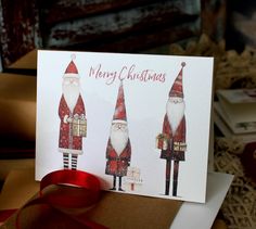 a christmas card with three santas on it and a red ribbon around the edge