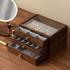 The Wooden Jewelry Box offers versatile storage and organization options to accommodate various types of jewelry. With multiple compartments, including dedicated slots for earrings, hooks for necklaces and bracelets, and compartments for rings and other small accessories, this organizer ensures that each piece has its designated place.    The soft velvet-lined interior adds a luxurious touch, preventing scratches and keeping your jewelry in pristine condition. The removable dividers provide flex Organizer For Jewelry, Wooden Jewelry Organizer, Jewelry Display Case Ideas, Jewellery Box Aesthetic, Luxury Wooden Boxes, Modern Jewelry Box, Jewelry Box Design, Ring Organizer, Types Of Jewelry