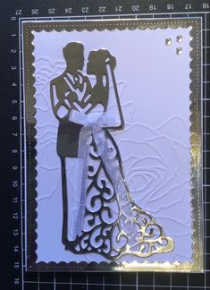 a wedding card with a cutout of a bride and groom holding each other's hand