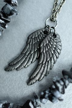 With this black wings necklace reminiscent of crows and ravens, you can fly away to a better place. This two wings necklace is the ideal fandom accessory for Castiel and Lucifer fans who love the fallen angels. Pair it with a goth casual cosplay look for your next convention. Or, wear it any day you want to feel dark, gothic, and powerful.  * Gunmetal-plated charms, components, & chain * Necklace length (pictured) - 18 inches (45.7 cm) long * Wing charms - Just over 1 inch long by just under 0.5 inches wide (2.8 cm long by 1.1 cm wide) * Your necklace will be the same design as the one pictured above, but not the exact necklace shown. * Sales tax will be added at checkout for shipments to Washington state. * Need faster delivery? Add to your cart or buy now to see all shipping options! Als Crow Wings, Raven Wings, Wings Black, Feel Powerful, Wings Necklace, Fallen Angels, Casual Cosplay, Black Wings, Wing Necklace