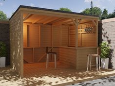 an outdoor sauna is shown with two stools and a bar in the background