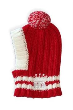 a red and white knitted hat with the letter d on it