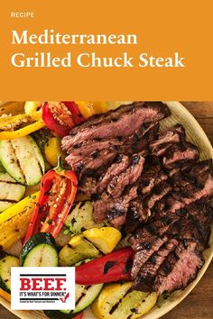 the recipe for mediterranean grilled chuck steak on a plate with zucchini and peppers