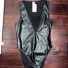 Black Leather Bodysuit. Never Worn. Size Medium Trendy Lined Bodysuit For Night Out, Trendy Bodysuit With Lined Body For Night Out, Edgy Sleeveless Bodysuit For Night Out, Edgy Bodysuit For Spring Night Out, Edgy Bodysuit For Night Out In Spring, Sleek Black Bodysuit For Spring, Sleek Spring Party Bodysuit, Chic Faux Leather Party Bodysuit, Sleek Bodysuit For Night Out In Spring