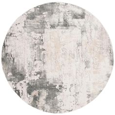 a round rug with white and gray paint on it