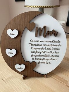 a mother's love plaque with three hearts on it and the words mom written in cursive font