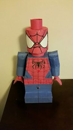 a lego spider man with a top hat on it's head sitting on a table