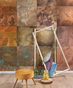 a living room with an abstract wallpaper and wooden flooring, including a round ottoman