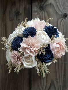 a bridal bouquet with blue, pink and white flowers