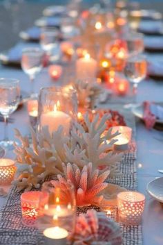 a table topped with lots of candles and plates