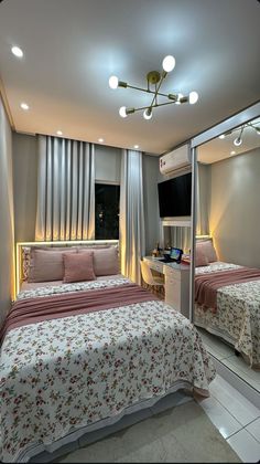 two beds in a room with lights on the ceiling