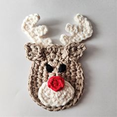 a crocheted reindeer ornament with a red nose