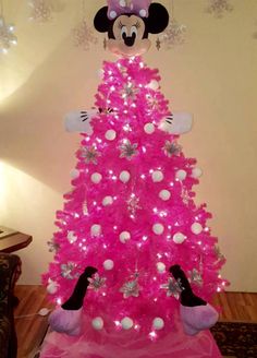 a pink christmas tree with minnie mouse decorations