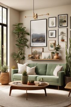 Modern living room with a green sofa, large plants, and a gallery wall of nature-themed artwork. Over Sofa Wall Decor Ideas Living Rooms, Wall Idea For Living Room, Living Room Designs Photo Wall, Living Room Art Arrangement, Ideas For A Wall In Living Room, Blank Wall Next To Tv, Home Decor Ideas White Walls, Gallery Wall With Greenery, Limited Wall Space Living Room