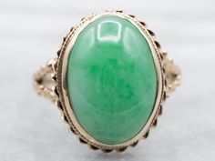 "The shoulders of this vintage ring are a perfectly balanced band of perfectly polished gold!  The nautical rope twist design and decoration of the mounting really make a great frame for this sleek piece of oval Jade; that has a wonderful earthy apple green color and polished look. Metal: 14K Yellow Gold Gem: Jade Gem Measurements: 13.3 x 19.6 mm, Oval Ring Size: 13.75 Marks: \"14K\" Stamped on the inside band To view a video of this piece check out the link below: https://vimeo.com/832402657 SK Apple Green Color, Ring Green Stone, Right Hand Ring, Nautical Rope, Rope Twist, Right Hand Rings, Hand Ring, Oval Ring, Cabochon Ring