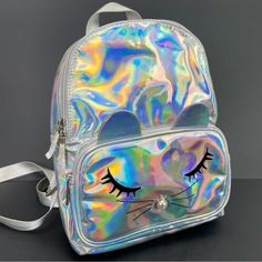 Olivia Miller Handbag Collection Backpack Iridescent Silver Purse Mouse Bag Tote Approximate Measurements: 11in X 9in X 5in Condition: New Without Tags. Never Used. Ebpome Iridescent Bag With Zipper Closure For Everyday Use, Everyday Iridescent Bag With Zipper Closure, Iridescent Everyday Bags With Zipper Closure, Iridescent Bags With Zipper Closure For Everyday Use, Trendy Iridescent Bags, Iridescent Rectangular Travel Bag, Trendy Metallic Travel Bag, Trendy Metallic Bags For Daily Use, Iridescent Trendy Bag For Everyday Use