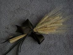 a bunch of wheat sitting on top of a gray carpet next to a black bow