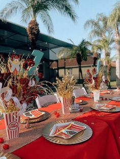 the table is set with red and gold decorations