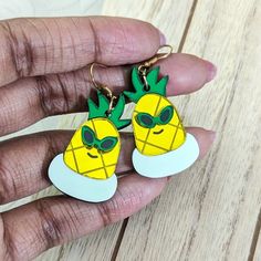 This pineapple is enjoying its pool time in its floaty. Lightweight earrings made with shiny yellow and green acrylics with hand-painted details and a pastel inner tube. These come with a fishhook backing. You may alternatively select ball post studs, huggie/leverbacks, or clip-ons. Metal is gold-toned, if you would like silver-toned metal, add it to the special instructions in your cart! Dimensions: Dangle Earrings: 1.5 in (38 mm) L x 1.25 in (32 mm) W The drop length is about 2.0 in (51 mm). M Playful Green Earrings For Summer, Playful Green Summer Jewelry, Summer Green Playful Jewelry, Fun Drop Earrings For Beach, Fun Yellow Earrings For Summer, Playful Summer Drop Earrings, Hand Painted Green Summer Earrings, Hand Painted Yellow Earrings For Summer, Green Resin Earrings For Summer