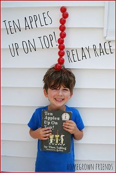 a young boy holding up a book with the title ten apples upon top relay race