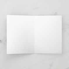 an open white paper on a marble surface