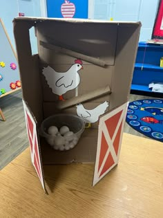 an open cardboard box with some eggs in it