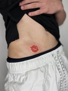 a woman's stomach with red lipstick on her lower body and the bottom part of her abdomen